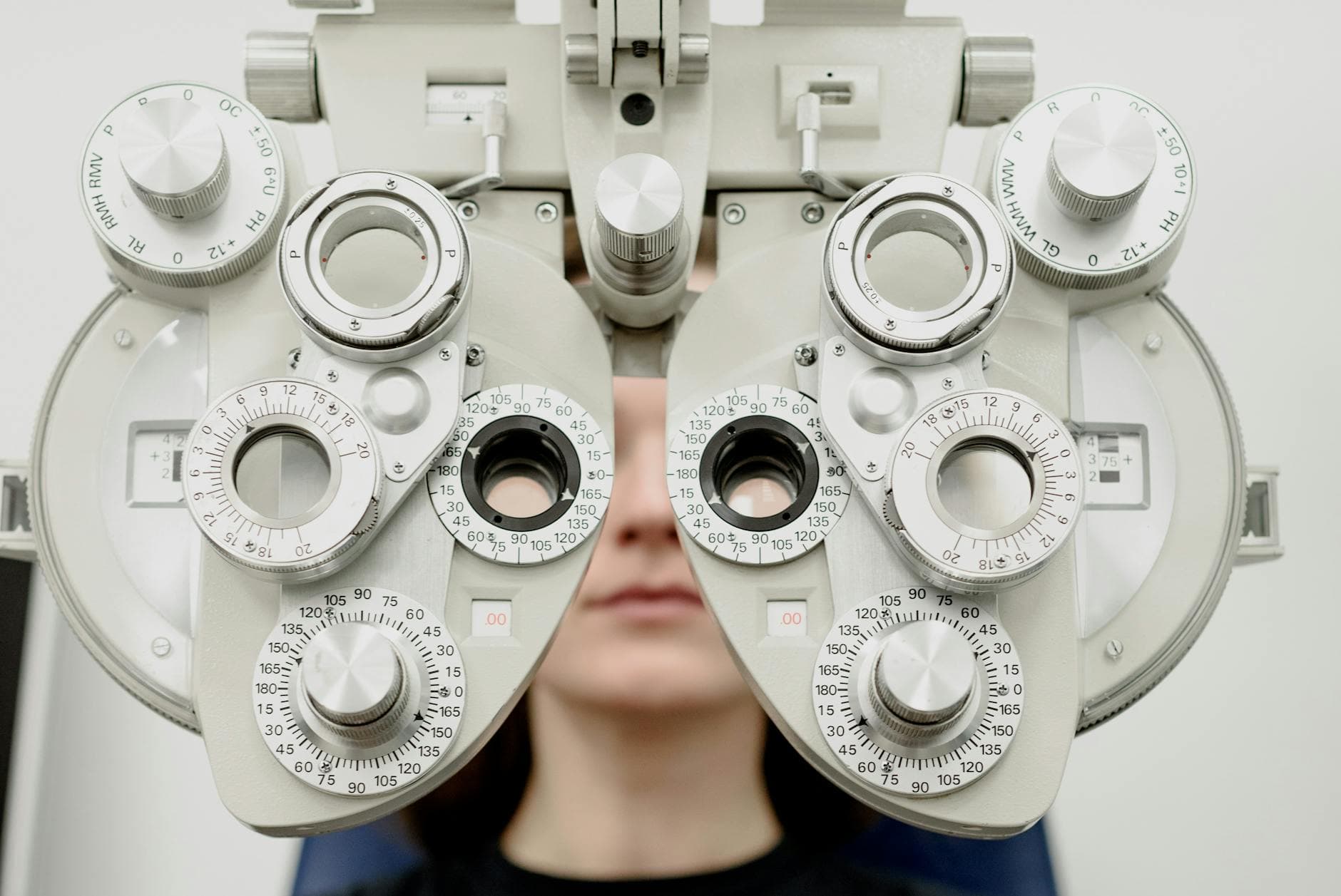 Optometrist performing an eye exam on a patient